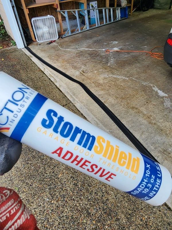 Tube of adhesive for garage threshold