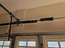 Garage door mechanism with pulley system