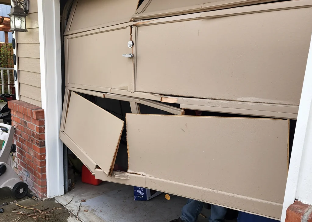 Damaged garage door with broken panels