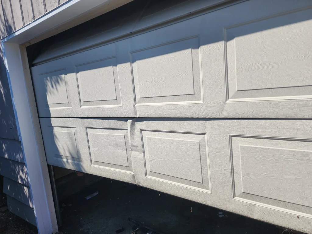 Damaged garage door partially open